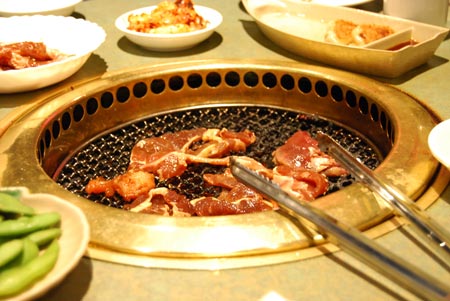 A barbeque pit in the table.