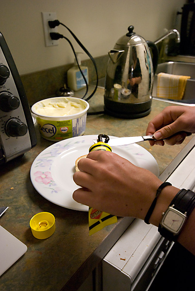 Carefully applying the Vegemite to the knife.